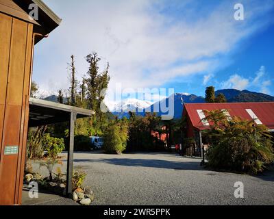 A house surrounded by trees on a gravel field. Franz Josef, Waiau, Franz Josef Glacier, New Zealand Stock Photo