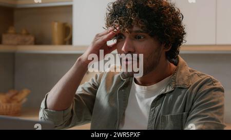 Shocked surprised amazed Indian male businessman astonish wonder excited guy Arabian man happy win with laptop winning online bet offer opportunity Stock Photo