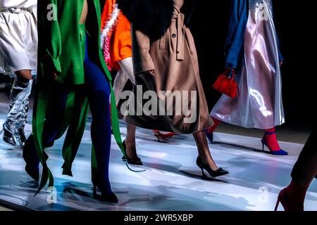 Models in trendy fashion outfits at the fashion show finale. Women's modern stylish clothing Stock Photo