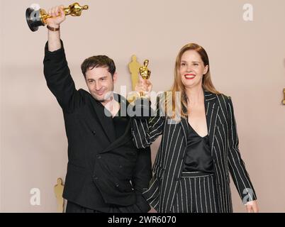 Los Angeles, USA. 10th Mar, 2024. (L-R) Arthur Harari and Justine Triet, winners of the Original Screenplay Award for “Anatomy of a Fall,” pose in the press room at the The 96th Academy Awards held by the Academy of Motion Picture Arts and Sciences at the Dolby Theatre in Los Angeles, CA on Sunday, March 10, 2024. (Photo by Sthanlee B. Mirador/Sipa USA) Credit: Sipa USA/Alamy Live News Stock Photo