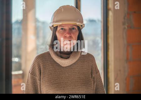Portrait of female architect on building construction site during inspection procedure, selective focus Stock Photo