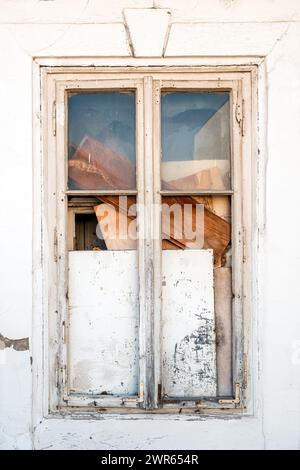 Old closed wooden window with broken glass, vertical image Stock Photo