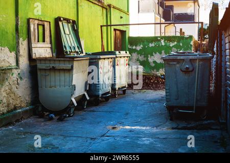 Trash container dumpsters in dirty alley, selective focus Stock Photo