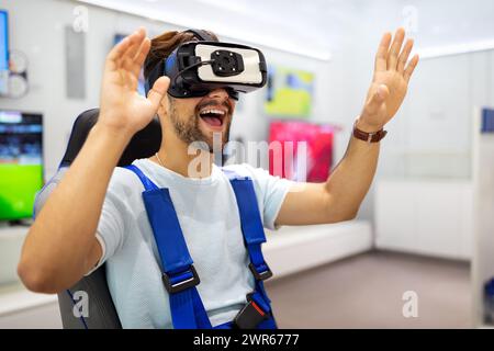 Portrait of man using virtual reality headset at exhibition show. VR technology simulation concept Stock Photo