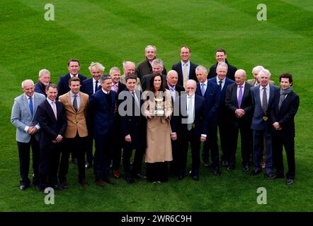 Jockey Rachael Blackmore (centre) holds the Gold Cup trophy as she poses for a photo with previous Gold Cup winning jockeys at Cheltenham Racecourse, ahead of the 2024 Cheltenham Festival, which begins tomorrow. Picture date: Monday March 11, 2024. Stock Photo