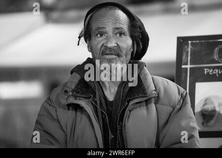 An elderly Rastafarian without a roof sits at the bar, exuding wisdom and resilience amidst adversity. Stock Photo