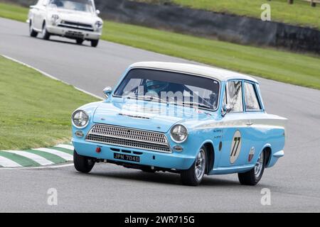 Mark Sumpter in the 1966 Ford-Lotus Cortina MkI during the Jim Clark Trophy race at Goodwood 80th Members Meeting, Sussex, UK Stock Photo