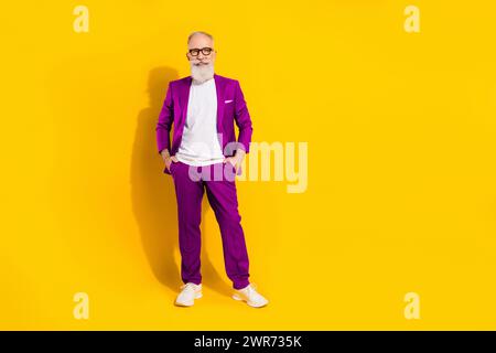 Full length body size photo of man wearing blue suit smiling isolated on bright yellow color background with copyspace Stock Photo