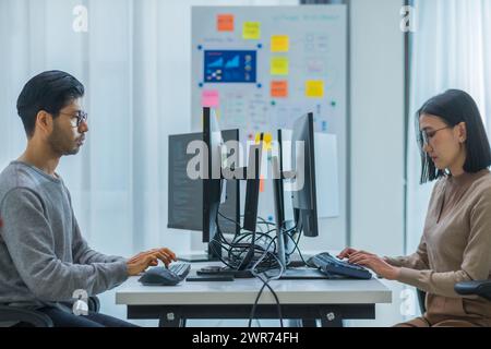 asian woman  and Indian man Developer team working  about programming software data online at office Stock Photo