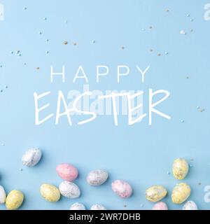Festive Easter card. Multicoloured Easter eggs on a blue background. Stock Photo
