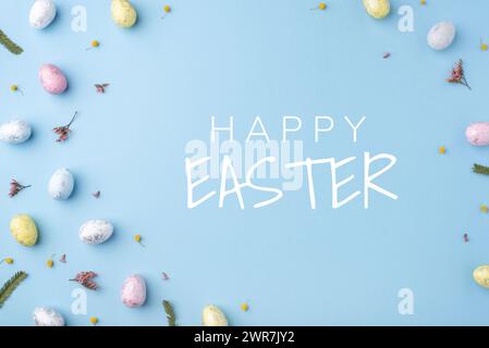 Festive Easter card. Multicoloured Easter eggs on a blue background. Stock Photo