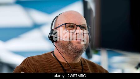 Male Customer Services Agent In Call Centre Stock Photo