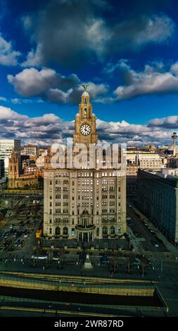 Dramatic sky over historic clock tower building in urban landscape in Liverpool, UK. Stock Photo