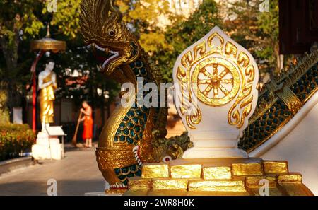 Main symbol of Buddhism is the Dharmachakra (Dharma Wheel) in a Buddhist monastery; concept of harmony, relaxation and tranquility Stock Photo