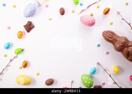 Chocolate eggs, chocolate bunny and sweets on white wooden table.Greetings card, Happy Easters. Flat lay ,top view Stock Photo