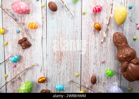 Chocolate eggs, chocolate bunny and sweets on wooden table.Greetings card, Happy Easters. Flat lay ,top view Stock Photo