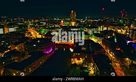 Aerial night view of a vibrant cityscape with illuminated buildings and streets in Leeds, UK. Stock Photo