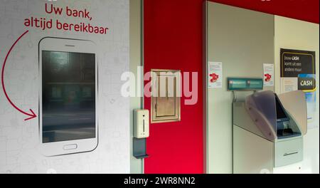 Indoor ATM cash dispenser / cashpoint of Belfius bank office in village, East Flanders, Belgium Stock Photo