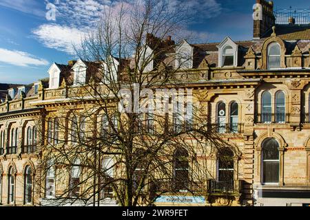 Vintage building corner against a dramatic cloudy sky in Harrogate, England. Stock Photo