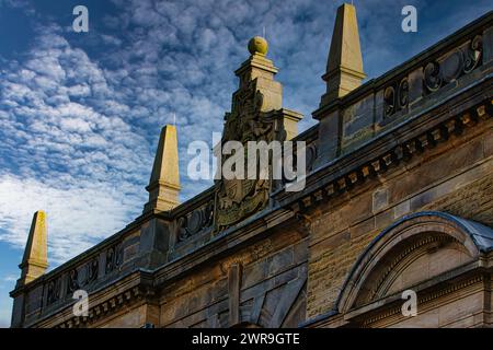 Historic building facade with ornate sculptures against a blue sky with clouds in Harrogate, England. Stock Photo