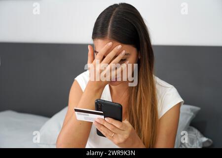 Digital theft. Desperate girl finds out that her credit card was cloned and her bank account emptied. Cyber security concept. Stock Photo
