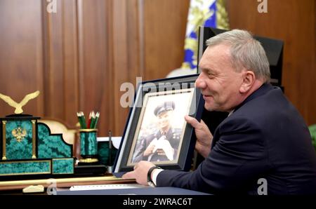 Moscow, Russia. 11th Mar, 2024. Russian state space agency Roscosmos Director General Yury Borisov shows a photo of the first man in space, Yury Gagarin, to Russian President Vladimir Putin, during a meeting at the Kremlin, March 11, 2024 in Moscow, Russia. This year marks the 90th birthday anniversary of cosmonaut Yury Gagarin. Credit: Mikhail Metzel/Kremlin Pool/Alamy Live News Stock Photo