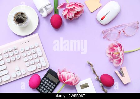 Frame made of modern gadgets, cup of coffee, tulips and Easter eggs on lilac background Stock Photo