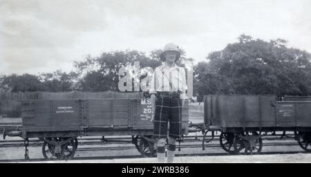 A Major in the 2nd Battalion Highland Light Infantry in front of Madras and Southern Mahratta Railway trucks in British India, c. 1925. Stock Photo