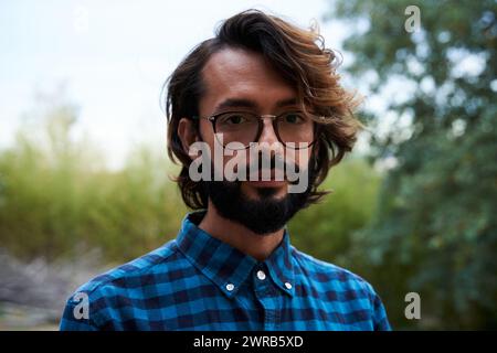 Portrait of serious Italian mature guy looking at the camera confident, standing outside in nature. Stock Photo
