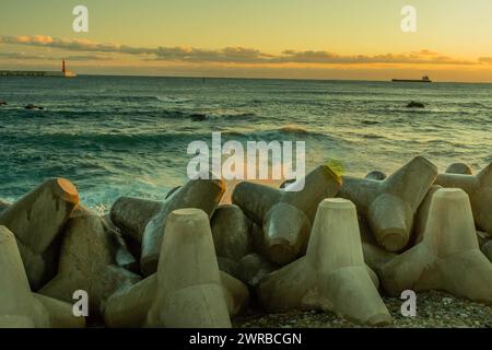 Seascape with concrete tetrapods on breakwater during dusk, creating a tranquil scene, in South Korea Stock Photo