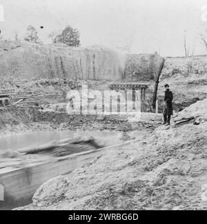 Dutch Gap Canal ... November 1864, while Canal was being dug, Soldier standing on cliff of canal., photographed 1864, printed later, Canals, Virginia, James River, 1860-1870, Photographic prints, 1860-1910., Photographic prints, 1860-1910, 1 photographic print Stock Photo