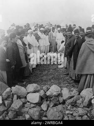 Palestine - Mt. Gerizin ie. Gerizim, Feast of the Passover, Samaritans around meat being cooked over open fire, Mount Gerizim, West Bank., between 1880 and 1922, Samaritans, Spiritual life, West Bank, Gerizim, Mount, Photographic prints, 1880-1920., Photographic prints, 1880-1920, 1 photographic print Stock Photo