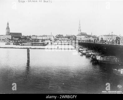 Riga - bridge of boats, Photograph shows view across the Western Dvina River with boat bridge on right consisting of at least 33 boats (each is numbered) and cityscape in the background., 1919 Oct. 18., Pontoon bridges, Latvia, Rīga, 1910-1920, Cityscape photographs, 1910-1920., Cityscape photographs, 1910-1920, Photographic prints, 1910-1920, 1 photographic print Stock Photo