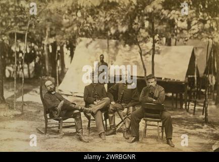 Bvt. Brig. Gen. Charles Francis Adams jr., General Charles Adams Jr., full-length portrait, seated facing front, in rocking chair next to three officers, also seated., 1864, Adams, Charles Francis, 1835-1915, Military service, Group portraits, 1860-1870., Group portraits, 1860-1870, Portrait photographs, 1860-1870, 1 photographic print Stock Photo