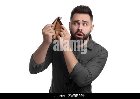 Confused man showing empty wallet on white background Stock Photo