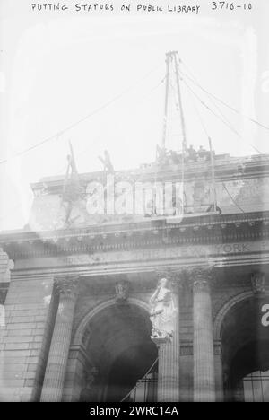 Putting statues on public library, Photograph shows the statue 'Romance' being lifted into place on the Fifth Avenue façade of the New York Public Library, New York City., 1915 Dec. 28, Glass negatives, 1 negative: glass Stock Photo