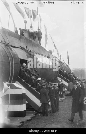 Jackies on U-Boat, Photograph shows the SM UC-5, a German Type UC I minelayer submarine (U-boat) which was captured by the Allies, brought to New York City and renamed U-Buy-a-Bond. The submarine took part in the Liberty Loan Parade in New York City on October 25, 1917., 1917, World War, 1914-1918, Glass negatives, 1 negative: glass Stock Photo