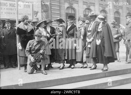 Browning gun, Photograph shows a soldier holding a M1918 Browning Automatic Rifle outside the New York Public Library during a Browning machine gun exhibit sponsored by the Mayor's Committee of Women on National Defense during World War I. A group of society women look on., 1918, World War, 1914-1918, Glass negatives, 1 negative: glass Stock Photo