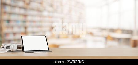 A digital tablet white-screen mockup, headphones, and books on a wooden desk with a blurred background of a library. 3d render, 3d illustration Stock Photo