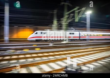 Berlin, Germany. 12th Mar, 2024. An ICE train leaves the Rummelsburg depot. The German Train Drivers' Union (GDL) has called for a further 24-hour strike in the collective bargaining dispute at Deutsche Bahn in passenger and freight transport. (Wiping effect by pulling along) Credit: Christoph Soeder/dpa/Alamy Live News Stock Photo