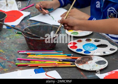 Oaxaca, Mexico - Students painting at a temporary art class in the zocalo. Stock Photo