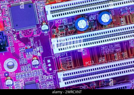 computer main board with sockets and chips. high-detailed view in blue red color. Stock Photo