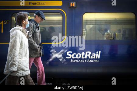 File photo dated 23/05/22 of commuters walking past a ScotRail train at Edinburgh's Waverley Station. More than £1.5 million has been paid out in compensation by ScotRail since the service was nationalised, according to new figures. The rail service was brought into public ownership in 2022 after a slew of failings by former operator Abellio. Issue date: Tuesday March 12, 2024. Stock Photo