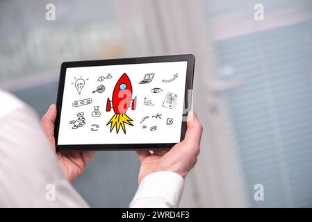 Start up concept shown on a tablet held by a man Stock Photo