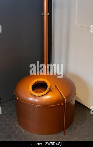 Copper brewing tank with wort in old brewhouse. Part of retro brewery. Stock Photo