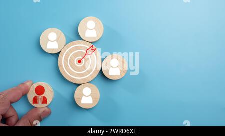 Circular wood with printed target icons and business symbols on light blue background, business goals and objectives concept, business competition, Cu Stock Photo