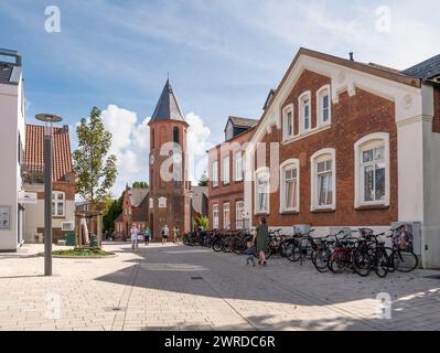 People walking in main street and bell tower, Wyk on Foehr, North Frisian island, Schleswig-Holstein, Germany Stock Photo