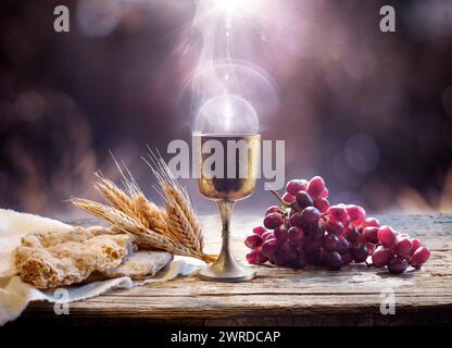 Communion - Holy Grail With Unleavened Bread And Chalice Of Wine - Last Supper With Corpus Christi Of Light Stock Photo