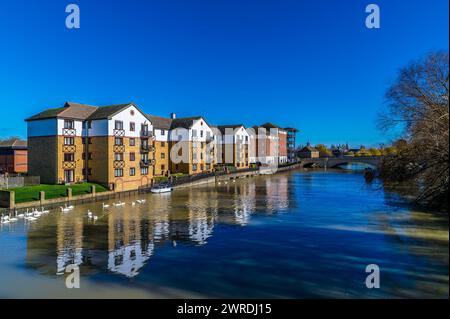 A view along the north shore of the River Nene in the centre of Peterborough, UK on a bright sunny day Stock Photo