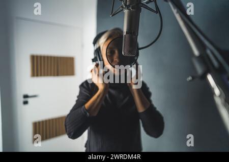 medium shot of a woman reporter working in a podcasting studio. High quality photo Stock Photo